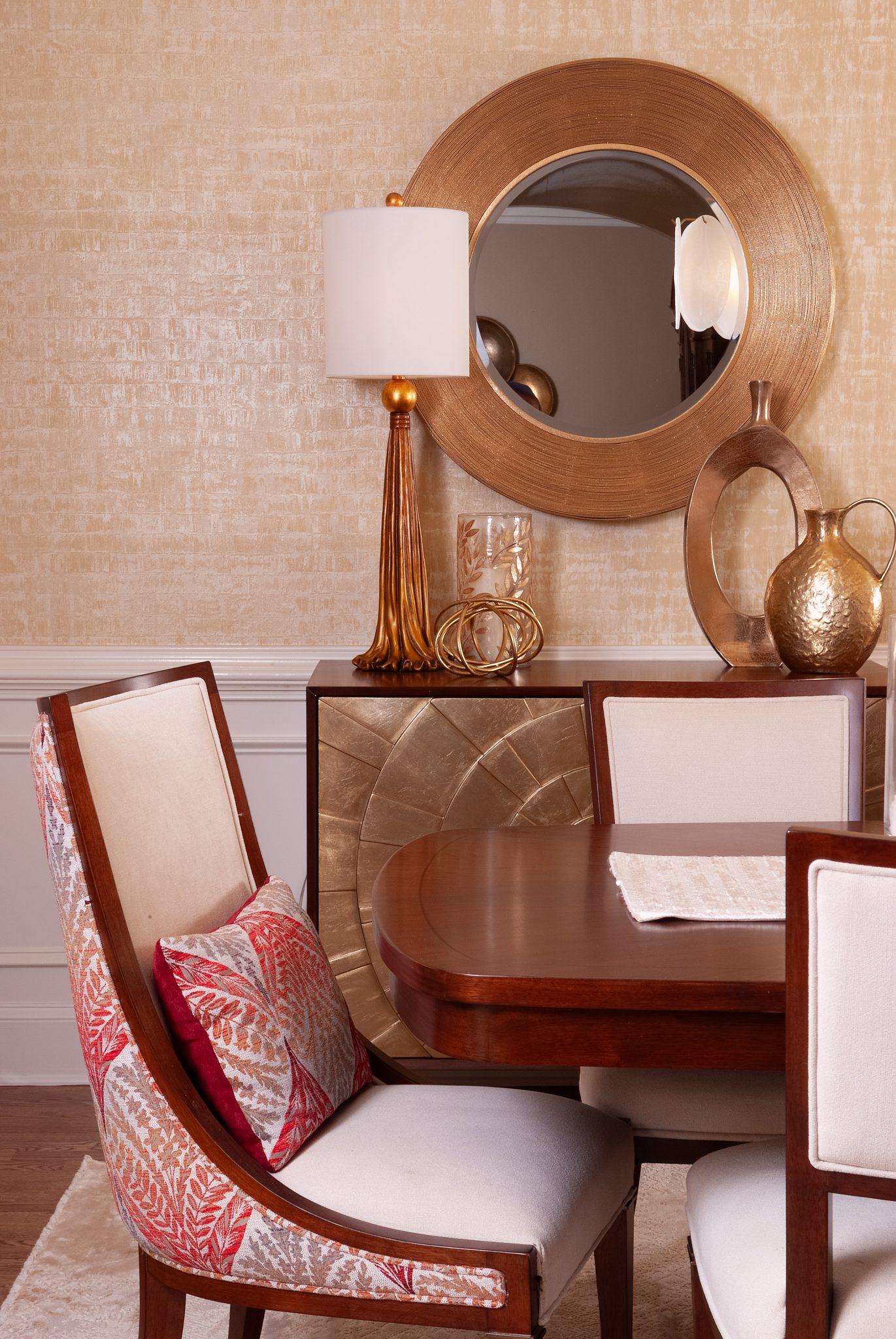 Gold mirror and lamp above dining buffet